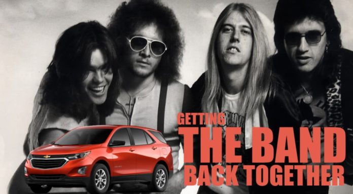 A red 2021 Chevy Equinox is shown parked in front of a black and white band photo after winning the 2021 Chevy Equinox vs 2021 Ford Escape comparison.