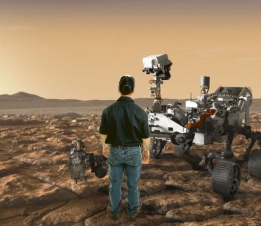 A man is shown standing on Mars in front of the NASA rover.