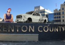 A man and a white Ram truck from a Ram dealer near Covington are behind the Kenton County sign.