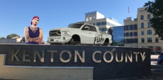 A man and a white Ram truck from a Ram dealer near Covington are behind the Kenton County sign.