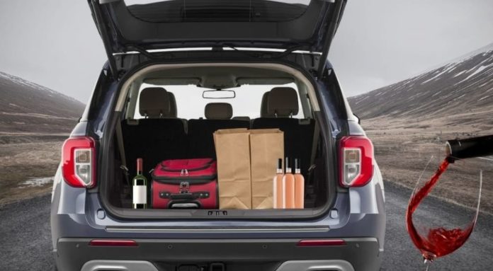The trunk of an SUV is filled with luggage and wine during a 2021 Ford Explorer vs 2021 Kia Telluride comparison.
