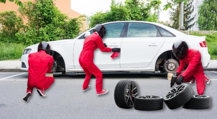 A white car is shown the with wheels being removed by a pit crew after leaving one of the most popular Cincinnati tire shops.