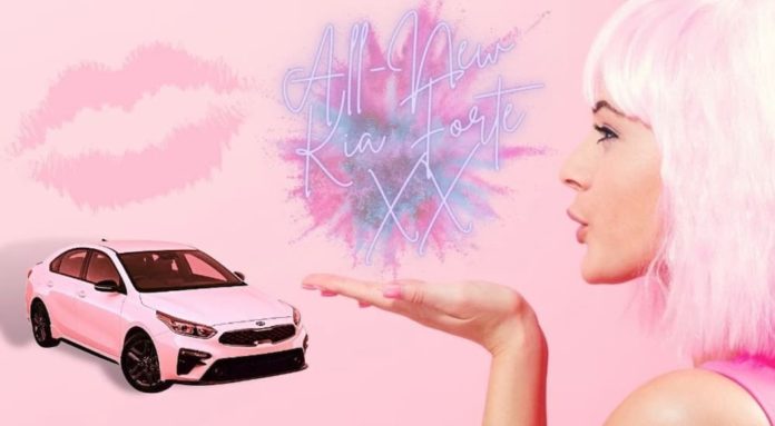 a woman is blowing a kiss towards a pink 2021 Kia Forte at a Kia Forte dealer.