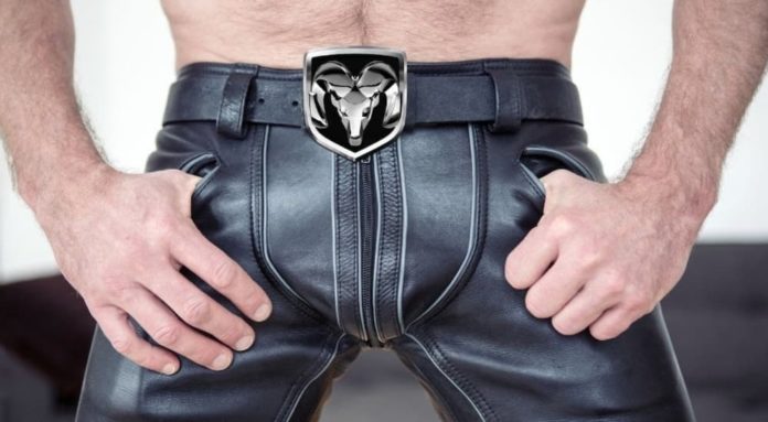 A man is shown wearing leather pants with a Ram belt buckle at a used Ram truck dealership.
