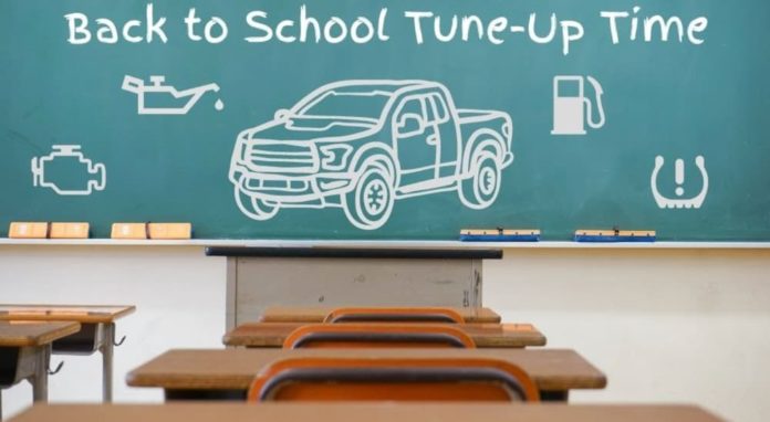 A classroom chalkboard shows a drawing of a 2022 Chevy Colorado.
