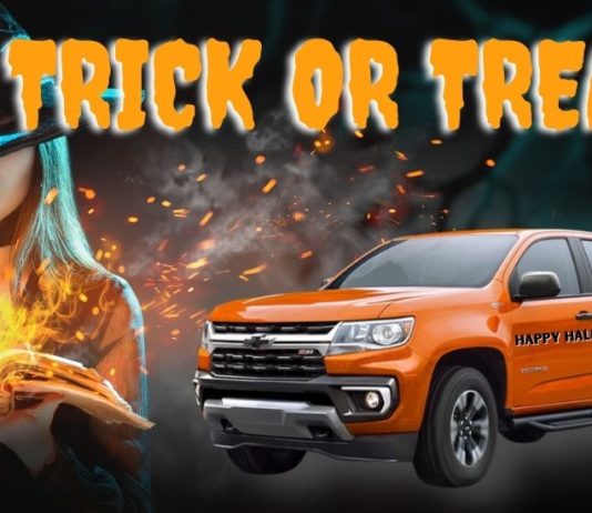 An orange 2022 Chevy Colorado is shown next a witch and the words 'trick or treat.'