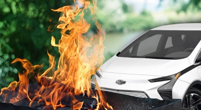 A white Chevy Bolt EV is shown on fire.
