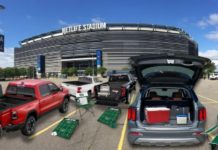 A tailgate party is shown outside of a stadium after leaving a New Jersey Kia dealership.