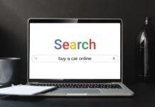 A laptop is shown on a search engine looking for online car sales.