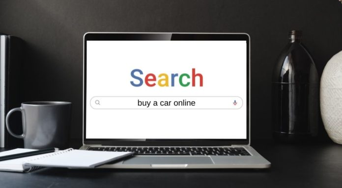 A laptop is shown on a search engine looking for online car sales.