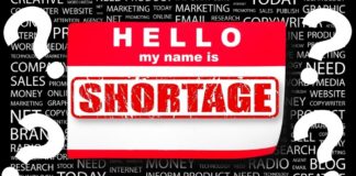 A sticker at a used car dealer says 'hello my name is shortage.'