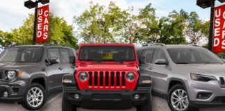A used Jeep Grand Cherokee L, Wrangler, and Renegade are shown at a used car dealer.
