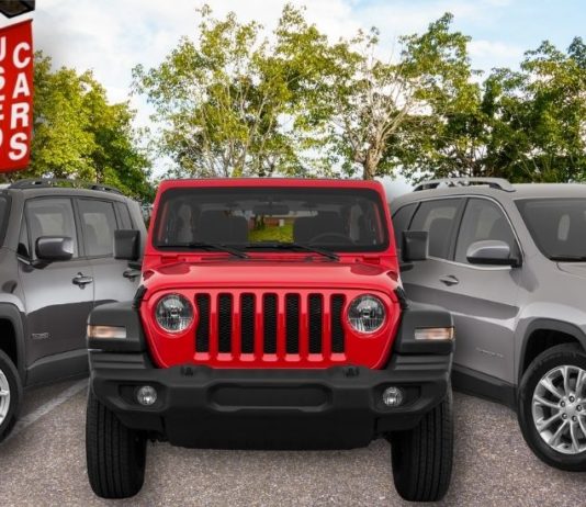 A used Jeep Grand Cherokee L, Wrangler, and Renegade are shown at a used car dealer.