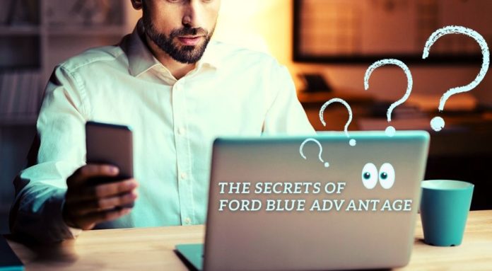 A man is shown using a laptop with a phone in his hand in a dark room after lookin up 'Certified Pre-Owned Ford dealer'.