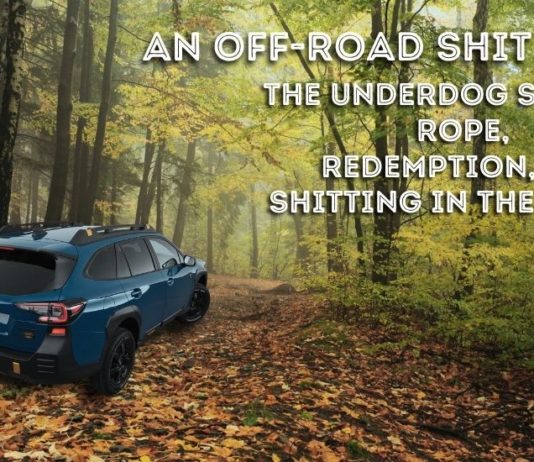 A blue 2022 Subaru Outback Wilderness is shown going down a trail from behind after leaving a 'Certified Pre-Owned Subaru dealership'.