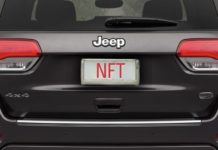 A grey 2022 Jeep Grand Cherokee WK is shown from the rear with a license plate that spells NFT.