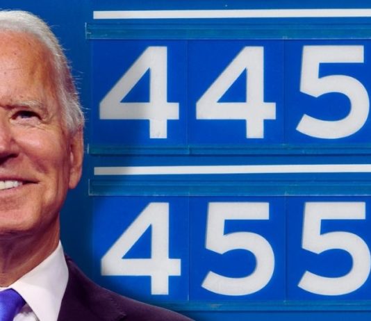 Joe Biden is shown in front of a sign for gas prices after allegedly infiltrating used car dealers.
