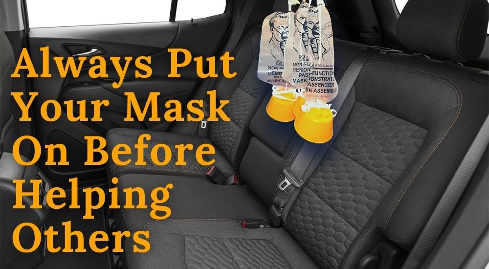 The seats of a Chevy Equinox are shown with airplane masks hanging from the ceiling.
