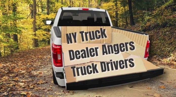 A truck is shown from behind with the bed replaced with cardboard after leaving an Albany F-150 dealer.