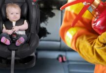 A baby in a carseat is shown in a Bolt EV next to a fireman.