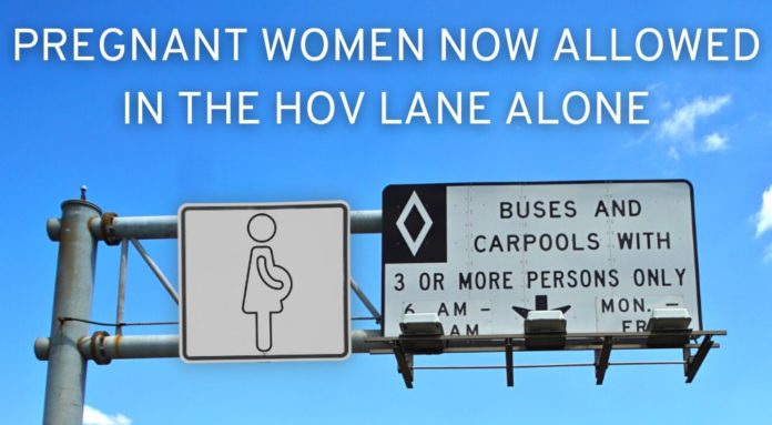 A road sign for an HOV lane is shown from a low angle.