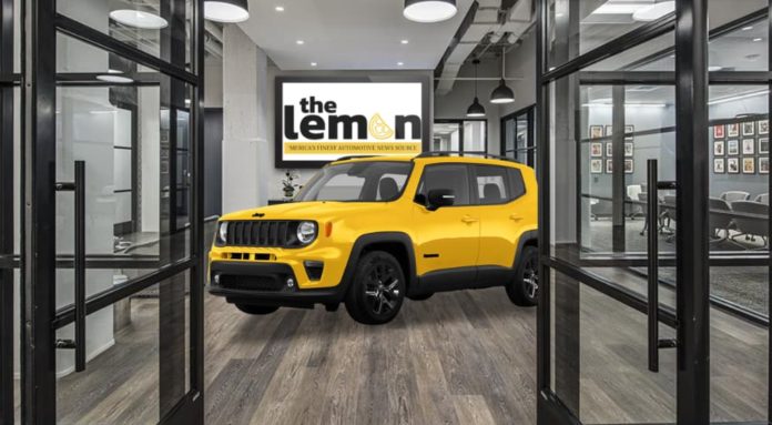 A yellow 2023 Jeep Renegade is shown from the front at an angle in The Lemon's office.