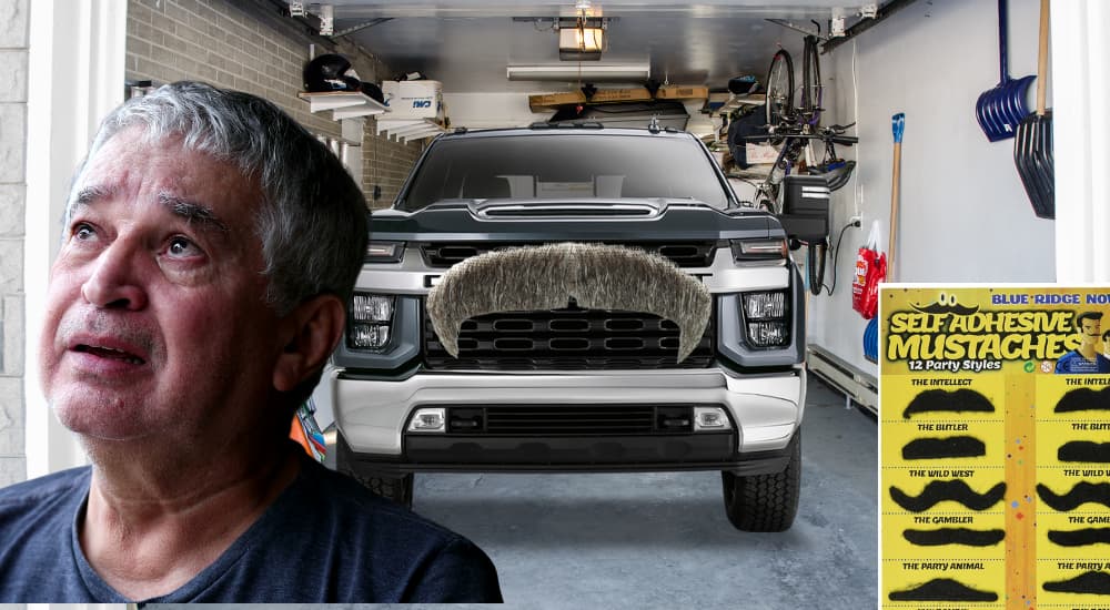 A Chevy Silverado is shown from the front wearing a mustache after leaving a dealer that has a GMC Sierra 1500 for sale.