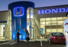 People are shown in front of a Honda dealer.
