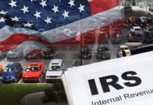 IRS paperwork is shown in front of parked cars.