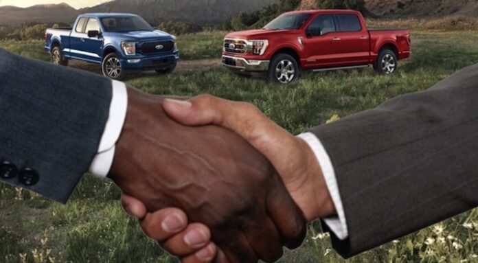 People are shown shaking hands in front of a Ford F-150 for sale near Citrus Heights, CA.