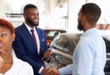 A customer is shown shaking a salesman's hand after buying a 2023 Honda CR-V Hybrid.