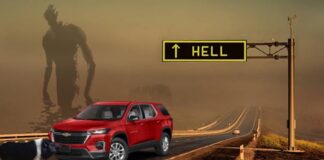 A red 2023 Chevy Traverse is shown on the highway to hell being held up by a pig with a large shadowy figure in the background.