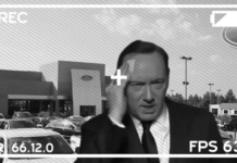 A security cam photograph depicting actor Kevin Spacey standing nervously in front of a Ford dealership after violating several Ford trucks for sale.