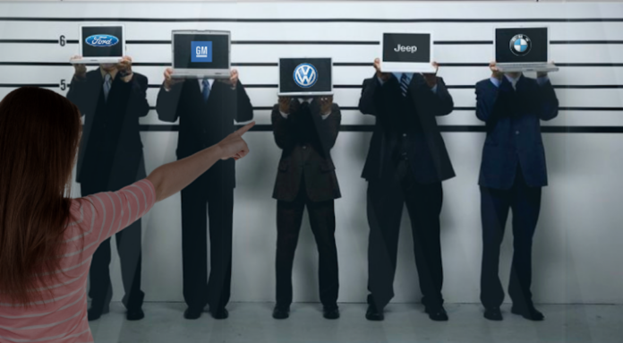 A police line-up of five men holding up laptops displaying the Ford, GM, Volkswagen, Jeep and BMW logos is shown.